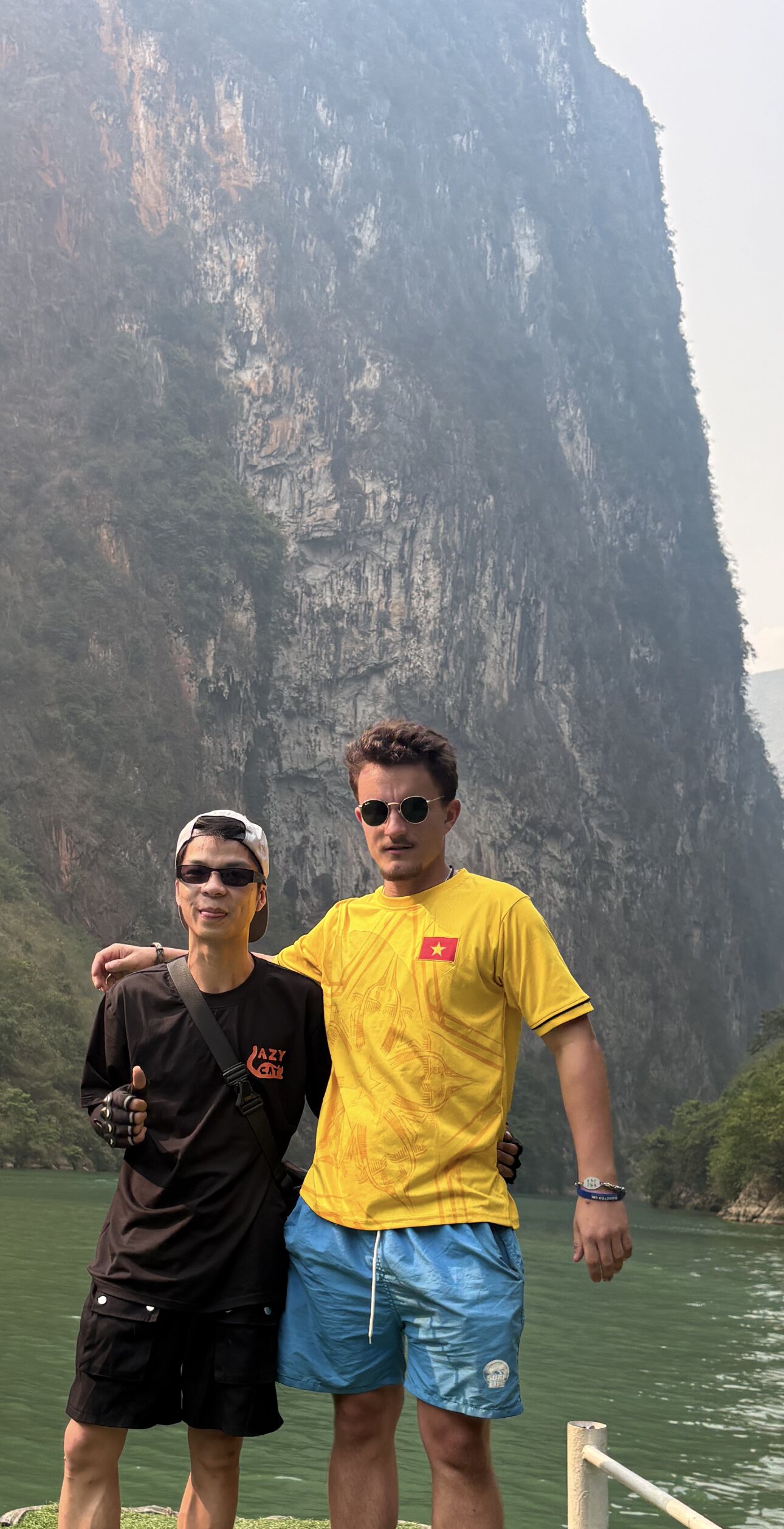 Ollie and a local guide in front of the Cao Bang limestone landscape